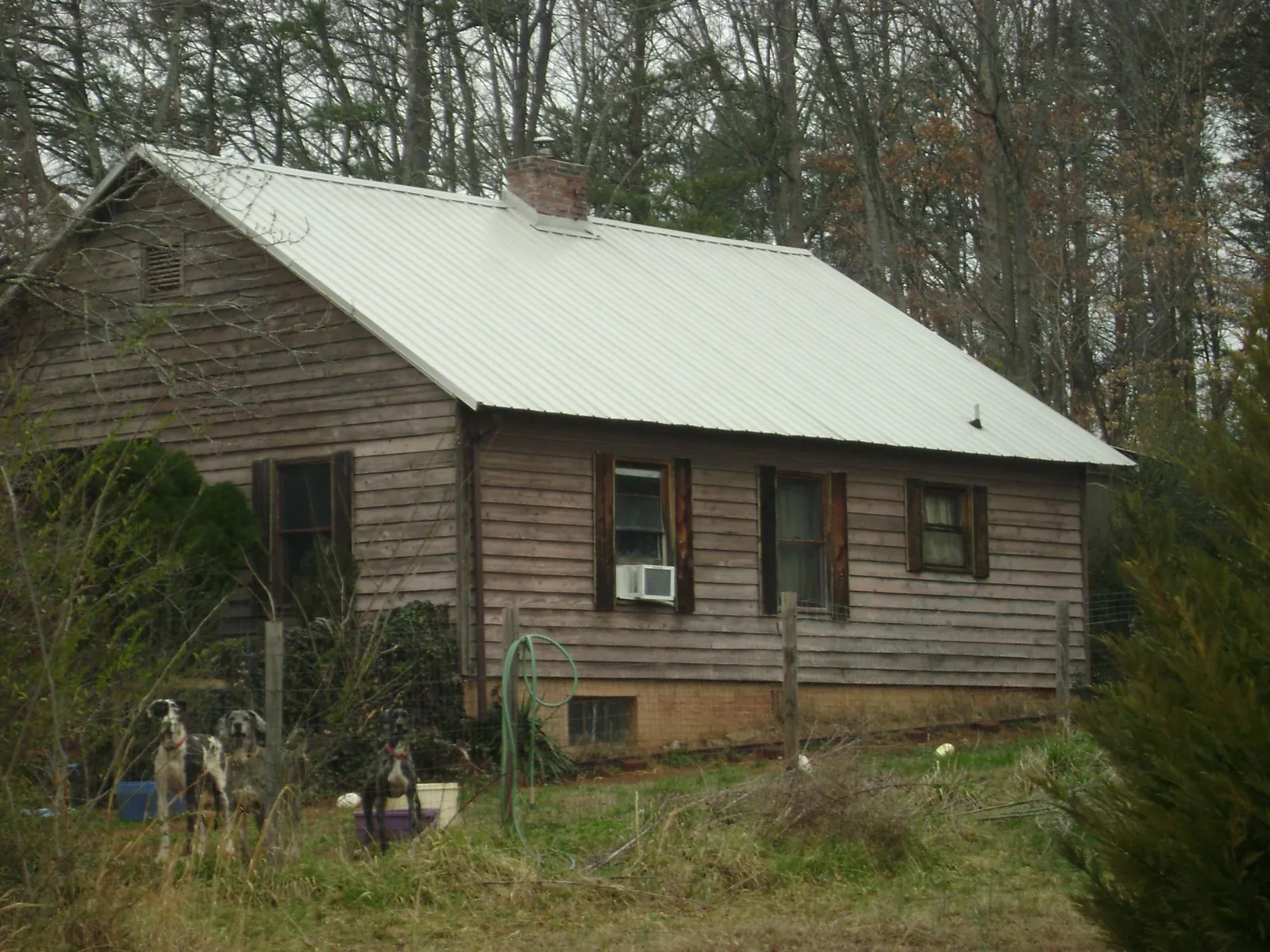 White metal roof on an old wood sided farmhouse, from a Metal Roof Installation job in Skaneateles